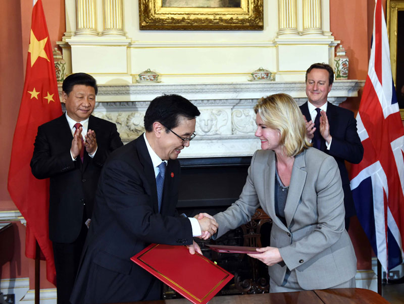 10月21日，國家主席習(xí)近平在倫敦唐寧街首相府同英國首相卡梅倫舉行會談。這是會談結(jié)束后，兩國領(lǐng)導(dǎo)人共同見証雙邊合作文件的簽署。新華社記者 饒愛民 攝